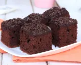 Fette di torta al cioccolato, soffici e ricoperte di scaglie di cioccolato fondente, pronte per essere gustate.