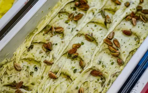 Gelato cremoso al pesto di pistacchio, guarnito con pistacchi interi tostati. Un'esplosione di gusto e colore.