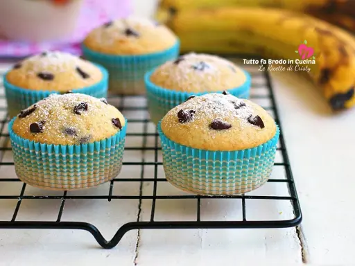 Muffin banana e cioccolato spolverati di zucchero a velo, pronti per essere gustati.