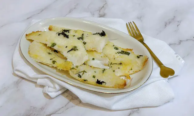 Delizioso merluzzo in friggitrice ad aria, croccante fuori e morbido dentro, guarnito con erbe aromatiche.