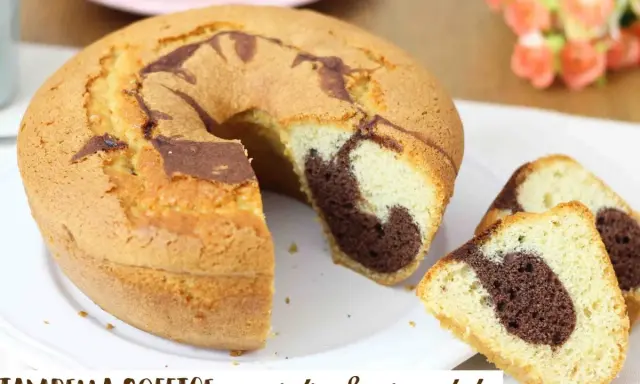 Ciambellone soffice alla vaniglia e cioccolato, con una fetta tagliata che mostra l'interno marmorizzato.