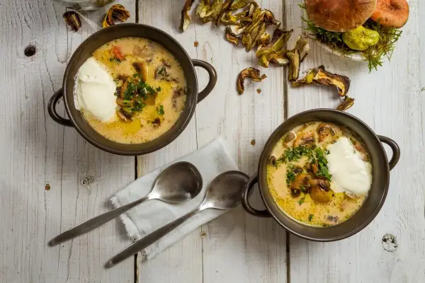 Zuppa cremosa ai funghi, un'idea su funghi secchi come cucinarli. Servita con panna e prezzemolo.